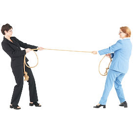 Two women pulling each other on rope