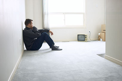 Man alone in empty apartment